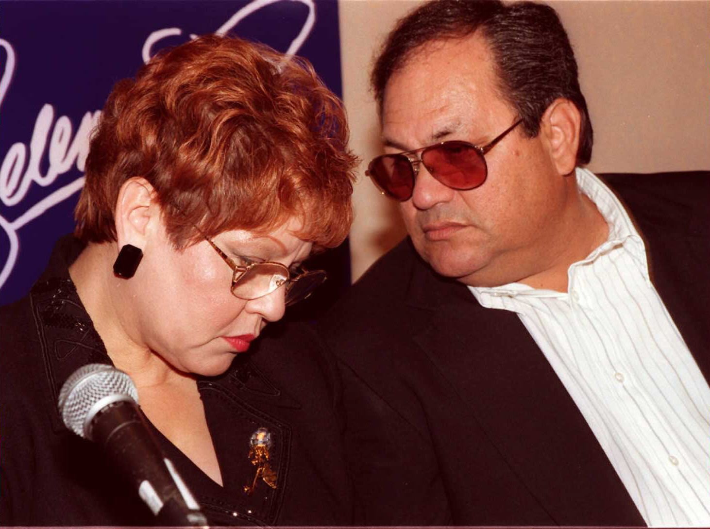 BEVERLY HILLS, UNITED STATES:  The parents of deceased Tejano singer Selena, Marcella and Abraham Quintanilla Jr. (R), confer at a press conference in Beverly Hills 18 June. The press conference was held to reveal the stars of the upcoming Warner Brothers Studio movie about Selena.  AFP PHOTO Tiziana SORGE (Photo credit should read TIZIANA SORGE/AFP via Getty Images)