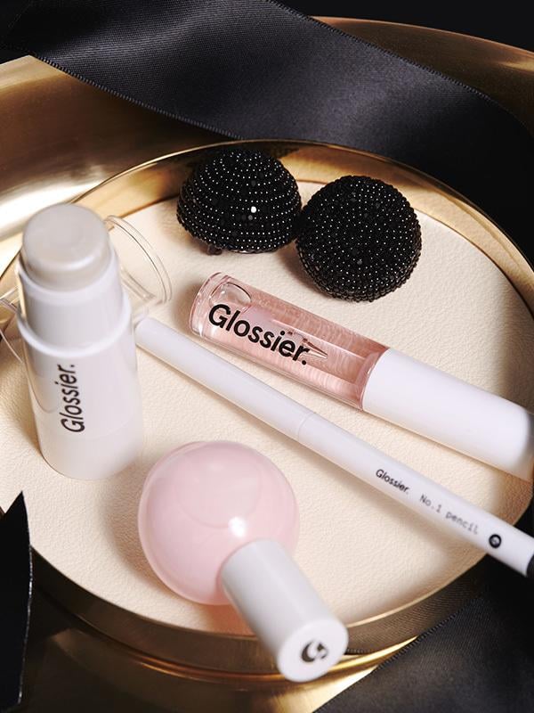 "I love that this includes some of the staple Glossier products and comes packaged and ready to go! It's the perfect kit for a quick mid-day freshen up that I can do in my car. It comes with a lip gloss, eye pencil, Haloscope highlighter, and nail polish. The packaging is so chic and wrapped with a black tie you could even wear that as a choker!"  
Glossier Black Tie Set ($50)