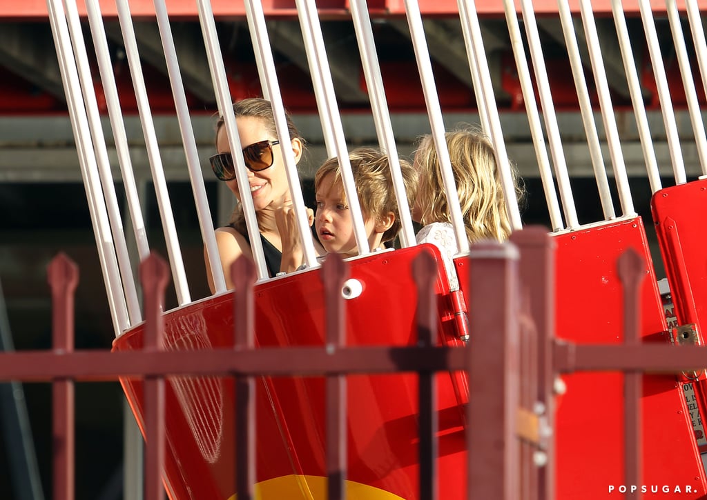 Angie smiled while in a ride with her little ones.