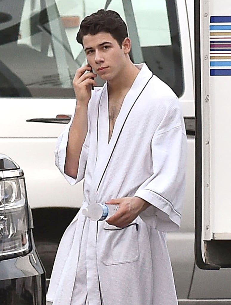 Nick Jonas covered up in a robe on the set of Scream Queens in New Orleans on Tuesday.